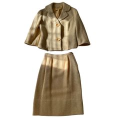 This Neiman Marcus Roth Le-Cover 2 Piece Wool Set is a vintage skirt suit from the 1960s. The set includes a beige skirt and jacket made of 100% wool. The suit is designed for women in the size range of S/M and has a classic style that would be perfect for any formal occasion. The brand of this suit is Neiman Marcus and it is in excellent shape. This item is a great addition to any vintage clothing collection. Vintage Beige Sets For Spring, Elegant Cream Colored Fall Sets, Elegant Cream Sets For Fall, Vintage Formal Sets For Fall, Classic Beige Skirt Suit For Spring, Beige Fitted Skirt Suit For Fall, Vintage Workwear Sets For Spring, Classic Beige Fitted Skirt Suit, Classic Tailored Beige Skirt Suit