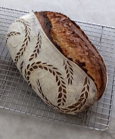 a loaf of bread sitting on top of a cooling rack