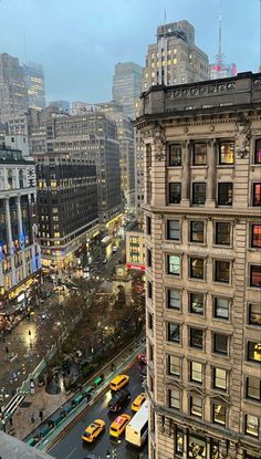 a city street filled with lots of traffic and tall buildings next to eachother