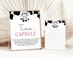 a cow themed time capsule is next to a notepad with the word time capsule written on it