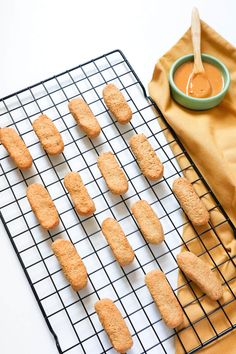 cookies on a cooling rack with dipping sauce in a bowl next to the baking sheet