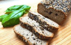 sliced loaf of bread with spinach leaves on cutting board