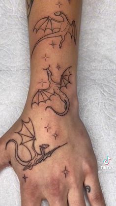 a hand with a dragon tattoo on it