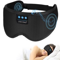 a woman laying in bed with a sleep mask on her head and an electric eye mask