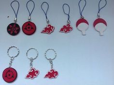 six key chains with different designs on them, one is red and the other is white