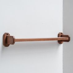 a close up of a wooden handle on a white wall