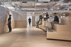 an office with people sitting and standing around