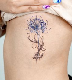 a woman's stomach with a flower tattoo on it