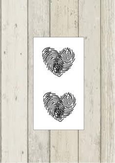 two fingerprints on wood with white background