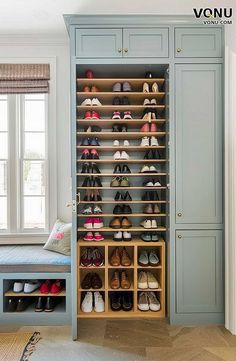 an organized closet with shoes on shelves and a bench in the corner next to it