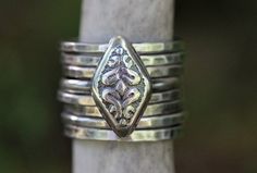 This sterling silver vintage inspired ring looks like a beautiful floral pattern or two serpents back to back with a diamond shape between them.  I make this ring using steel dies and raw silver sheet metal in my hydraulic press. It's such a pretty design with gorgeous texture and detail.  Wear it solo or stack it with simple silver bands or other stacking rings. You can buy simple silver stacking bands here:https://www.etsy.com/listing/532906393/silver-stacking-ring-simple-silver-ring?ref=shop_ Silver Stackable Rings, Silver Snake Ring, Vintage Inspired Rings, Stackable Rings Silver, Snake Ring Silver, Silver Rings Simple, Bohemian Ring, Stacking Bands, Rings Silver