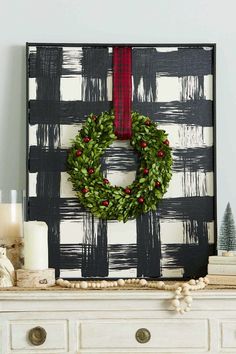 a decorated mantle with a wreath and candles