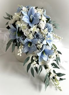 a bouquet of blue and white flowers in a vase