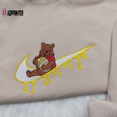 Introducing the Winnie the Pooh Nike Sweatshirt, a delightful fusion of childhood nostalgia and sporty style. Crafted with love, this sweatshirt showcases the iconic Pooh bear embroidered on the front, bringing back memories of whimsical adventures in the Hundred Acre Wood. The Disney Embroidered Hoodie is a must-have for any Disney enthusiast. With its intricate embroidery featuring beloved characters like Mickey Mouse and Cinderella, this hoodie is a wearable piece of Disney magic. Stay cozy a Cartoon Nike Hoodie, Winnie The Pooh Nike, Cow Outfits, Disney Clothes, Dope Outfits For Guys, Custom Nike, Cute Shirt Designs, Childhood Nostalgia, Nike Sweatshirt