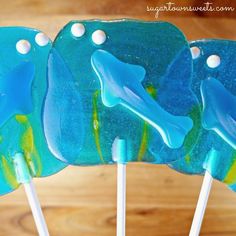 three lollipops with blue and green designs on them