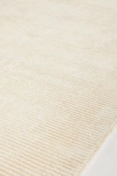 a close up view of a beige rug with vertical stripes on the top and bottom