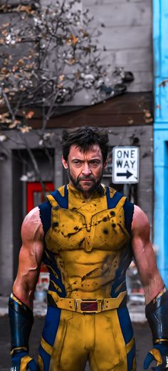 a man dressed as wolverine stands in front of a building