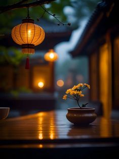 a vase with yellow flowers sitting on top of a wooden table next to a lamp