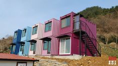 several multi - colored shipping containers are stacked on top of each other