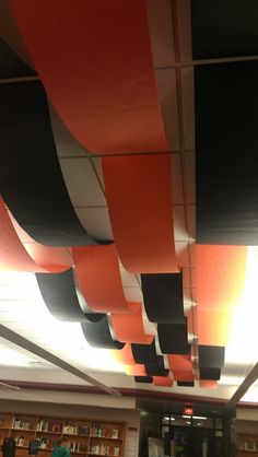 the ceiling is decorated with black, orange and white strips