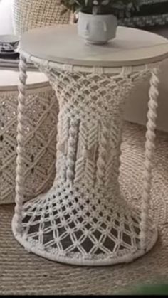 two white wicker chairs sitting next to each other on top of a carpeted floor