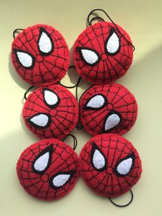 four spiderman balls with eyes on them