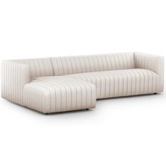 a white couch sitting on top of a white floor