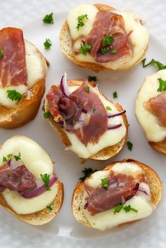 small appetizers with meat and cheese on bread