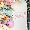 a cake decorated with flowers and eggs on top of a white sheet that says happy easter