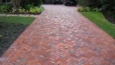 a red brick walkway leading to a house