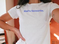 Dad's Favorite - funny trending shirt graphics printed in light blue on a lightweight cotton 90s-style baby tee. Please see the full product description below before making your order! ♥PRODUCTION TIME: 1-5 days (usually 2-3 days) ♥SHIPPING TIME: 3-5 days ♥PRODUCT DESCRIPTION: TRANSPARENCY DISCLAIMER / DISCLOSURE: these are "YOUTH" tees that fit the look of a baby tee that we all know & love! Super soft cotton and lightweight quality. 100% Soft cotton for the solid colors (fibre content may vary White Tops With Funny Print For Father's Day, Father's Day White Tops With Funny Print, Blue Tops With Screen Print For Father's Day, Blue Screen Print Tops For Father's Day, Retro Letter Print Tops For Father's Day, Cotton Tops With Funny Texts In Pop Culture Style, Cotton Tops With Funny Text In Pop Culture Style, Father's Day Blue Top With Funny Text, 90's Aesthetic