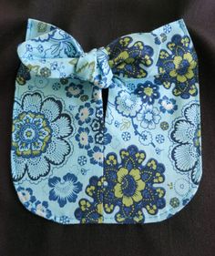 a blue and yellow flowered bow tie on top of a black cloth material background