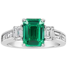 A wonderful engagement ring, showcasing a color-rich 1.66 carats emerald cut green emerald, set on a four prong setting. Flanked by two perfectly matched emerald cut diamonds. Accented by channel-set emerald cut diamonds weighing 0.75 carat total. Made with an 18K white gold mounting. A unique and elegant engagement ring. Size 4.75 US, resizable upon request. Roman Malakov is a custom house, specializing in creating anything you can imagine. If you would like to receive a special quote on a cust Antique Wedding Jewelry, Emerald Cut Diamond Engagement Ring, Diamond Sapphire Engagement Ring, Sapphire Diamond Engagement, Emerald Cut Engagement, Trending Engagement Rings, Elegant Engagement Rings, Gold Diamond Wedding Band, Ring Trends