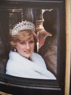 a woman wearing a tiara sitting in a car