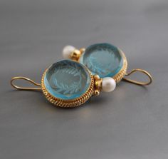 ✽ D E T A I L S   {Gemstone} - Blue Glass   {Gemstone Size} - 18 mm   {Earring Height Including Hoop} - 4 cm   {Earring Width} - 2  cm   {Finish} - Smooth and high polished with Little Oxide Antique Look.   {Note} -Production time is about 3-5 working days. The one you receive may be slight different from the one                  in the picture due to handmade nature, but it will be almost same as in the above picture.    These pieces are handcrafted from start to finish and have an imperfect handmade look.    These earrings are the perfect addition to your collection. Our rings are meant to be classic enough for everyday wear or to give as a     bridesmaid gift.    Gracefully designed, this pendant will surely be your timeless possession.    For wholesale discounts please contact me.   ✽ Blue Pierced Earrings For Wedding, Round Intaglio Earrings For Anniversary, Intaglio Drop Earrings For Gift, Vintage Intaglio Earrings For Wedding, Vintage Blue Hoop Earrings For Gift, Blue Ornate Handmade Earrings, Handmade Blue Ornate Earrings, Ornate Blue Pierced Earrings, Intaglio Jewelry