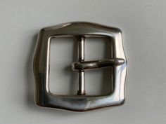 "Unique 70s style Centre bar belt buckle. Polished silver. A fun twist on a classic. Designed to be worn with 1.5\" (38mm) belt strap." Modern Silver Belt With Buckle Closure, Silver Belt With Buckle Closure For Formal Occasions, Classic Silver Belt For Formal Occasions, Classic Silver Formal Belt, Silver Classic Formal Belt, Modern Silver Belt For Formal Occasion, Modern Silver Belt Buckles For Formal Wear, Classic Silver Belt For Business, Classic Silver Belt Buckles For Business