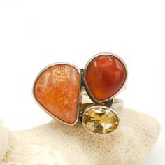 This big vintage sterling ring has a really nice sturdy, quality adjustable band.  Three stones in open backed settings are different sizes, shapes and colors which make me think of pop art.  The light kind of peachy brownish color has some almost sparkling flecks (very subtle) and the darker stone could be carnelian but I do not know and the yellow faceted stone I believe is a cubic zirconium.  Currently about a size 9 but it is adjustable and could easily be size 9 1/2 and go down to size 7 I Unique Orange Ring Jewelry, Unique Orange Cabochon Ring, Triple Hoop Earrings, Napier Jewelry, Art Ring, Costume Jewelry Rings, Big Hoop Earrings, Sterling Jewelry, Hinged Bangle