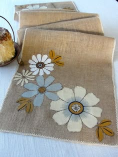 two place mats with flowers and leaves on them