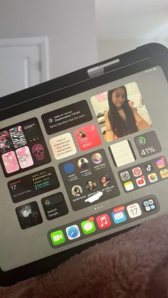 someone is holding an ipad with many app icons on it