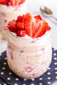 two mason jars filled with strawberry cheesecake overnight oatmeal