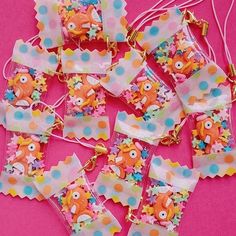 several pieces of colorful paper with polka dots and fish on them, all in different shapes and sizes