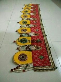 a row of different colored and beaded items on the floor