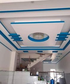 an empty kitchen with blue and white paint on the ceiling