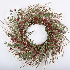 a wreath with red berries and green leaves