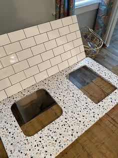 a bathroom counter with two square holes in it