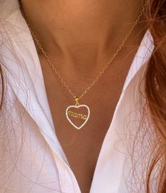 Discover our exquisite Gold Heart Necklace featuring a charming 'Mama' inscription nestled within a delicate heart adorned with minimalist zircons. Crafted from gold-plated sterling silver 925, the intricate design is showcased on adjustable 40cm chains with extension links at the clasp. Available exclusively at Christina Christi Store. 👉 My Womens Necklaces Collection: https://etsy.me/2G3pmJD 👉 Express Shipping: https://etsy.me/3ikUnOM MATERIALS - All my chains have the best quality (Gold Plated Sterling Silver 925), they don't get black with water and they don't create allergies. - Minimal zircons. DIMENSIONS - Mama in Heart necklace has length 40 cm (17.2'') - In all necklaces I use extension at the joined edges for perfect fit. - If you would like to have more or less cm to your neck Personalized Heart Necklace In Cubic Zirconia For Wedding, Personalized Cubic Zirconia Heart Necklace For Wedding, Cubic Zirconia Name Necklace For Gift, Elegant Heart-shaped Name Necklace For Mom, Dainty Heart Pendant Name Necklace For Mother's Day, Mother's Day Open Heart Cubic Zirconia Necklace, Elegant Heart Necklace With Name For Mom, Dainty Heart-shaped Name Necklace For Mom, Dainty Heart Shaped Name Necklace As Gift For Mom