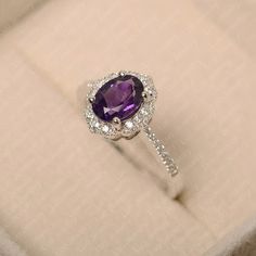 Elegant Oval Amethyst Promise Ring, Elegant Oval Amethyst Birthstone Ring, Elegant Purple Oval Birthstone Ring, Oval Amethyst Promise Ring In White Gold, White Gold Amethyst Promise Ring With Oval Shape, White Gold Oval Amethyst Promise Ring, Classic Oval Amethyst Ring With Halo Setting, Oval White Gold Amethyst Promise Ring, Oval Amethyst Ring In White Gold For Anniversary