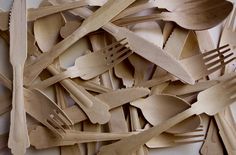 a pile of wooden spoons and forks