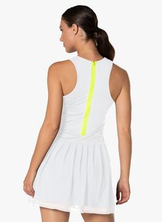 a woman wearing a white tennis dress with neon zippers on the front and back