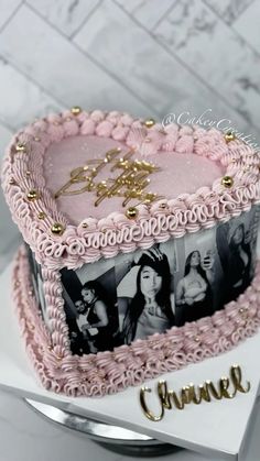 a pink cake decorated with photos and gold lettering